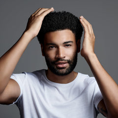 Jack Black Clay Pomade applied to textured hair for natural sculpting