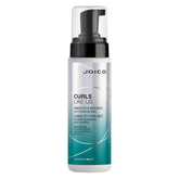 Joico Curls Like Us Smooth & Bounce Foam bottle shows lightweight hold for defined curls.
