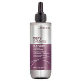 Joico Defy Damage In A Flash bottle being poured for quick bond support.