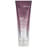 Joico Defy Damage Protective Conditioner bottle showing creamy formula for color protection and detangling