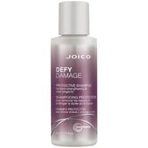 Joico Defy Damage Shampoo: botella vertiendo, limpieza suave que protege el color.