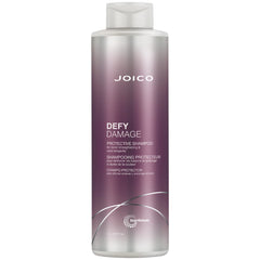 Joico Defy Damage Shampoo bottle close-up showing rich lather for color protection.