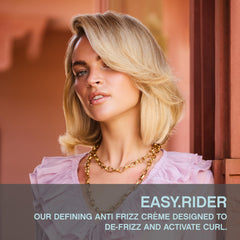 KEVIN.MURPHY EASY.RIDER hands applying cream for flexible hold and easy styling.