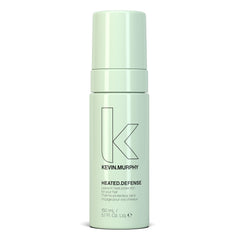KEVIN.MURPHY HEATED.DEFENSE bottle closeup showing heat protection for all hair types.