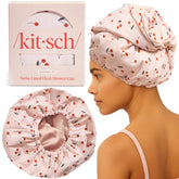 Kitsch Cherry Print shower cap worn by a woman for secure, dry hair protection.