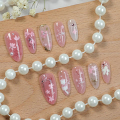 KRTBKR peach blossom design nails with 3D rhinestones for elegant party looks
