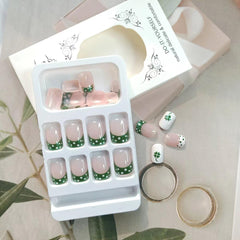 KRTBKR nails featuring white dots and green glitter for Shamrock accents