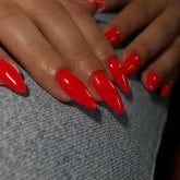 KXAMELIE orange-red almond press-on nails for a salon-style manicure at home.