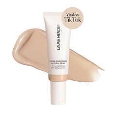Laura Mercier swatch on skin showing sheer to light coverage and hydration