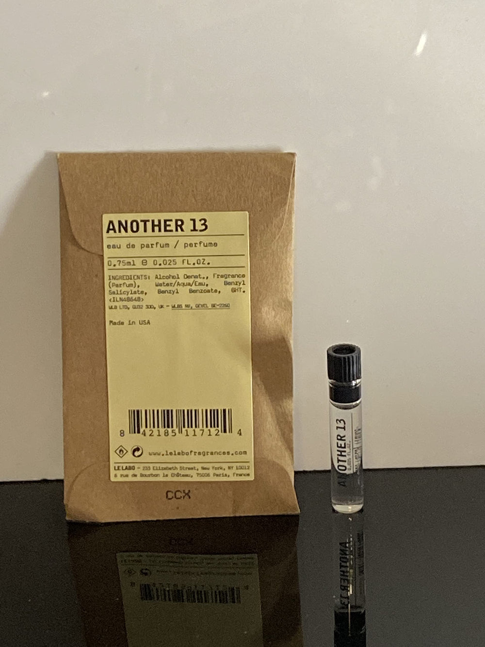 Le Labo Another 13 dabber sample bottle showing compact portability for on-the-go use.