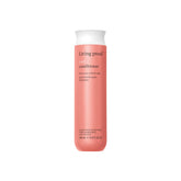 Living Proof Curl Conditioner bottle in shower promoting easy detangling and defined curls.