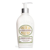 L'Occitane Almond Milk Veil bottle pour demonstrates fast-absorbing hydration for daily use.