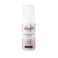 Loving Tan Deluxe Mousse applied with mitt for streak-free coverage.