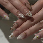 LPOODDNU white French tip almond nails with 3D flowers for a chic home manicure.