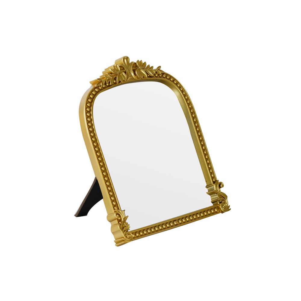 LuHeToz Gold Arched Mirror on a dresser adds vintage charm and practical reflection.