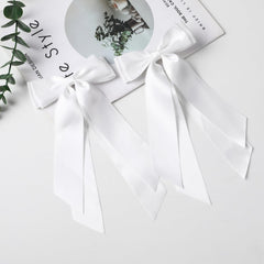 LuSeren white satin bows worn at weddings or parties.