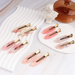 Magicsky celluloid clip mermaid-pink adds subtle shimmer while styling.