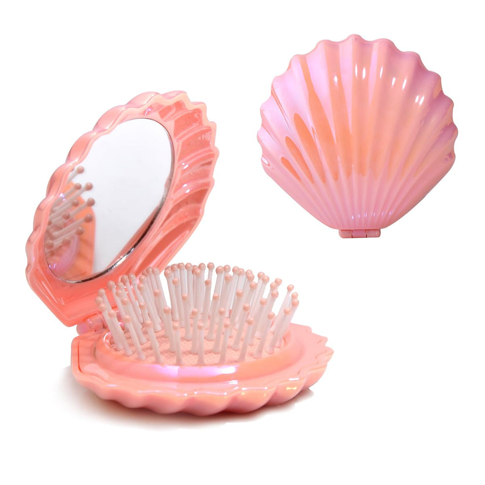 Maji Mama shell-shaped foldable travel brush in pink, ideal for on-the-go styling.