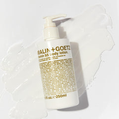 MALIN+GOETZ Vitamin B5 Body Lotion being applied to dry skin for moisture.