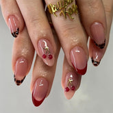 Mivota almond nails with 3D cherry and gold branch for a playful luxury manicure