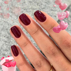 Modelones dark red squoval nails closeup, ready for quick style.