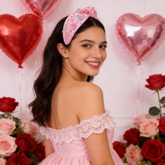 MOLOCH pink heart headband with knotted design for chic day-to-night style.