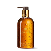 Molton Brown Mesmerising Oudh Gold hand wash bottle with opulent packaging for a luxurious daily ritual