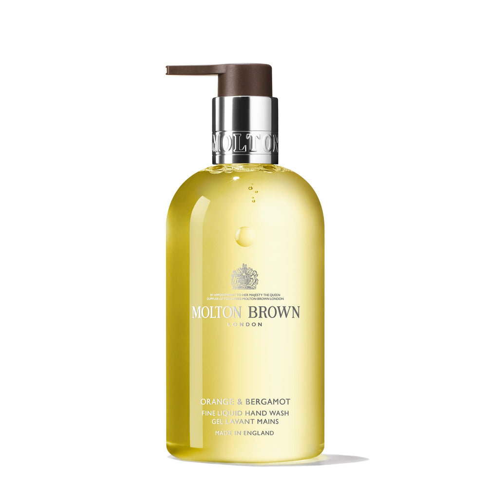 Molton Brown Orange & Bergamot hand wash bottle pour for uplifting citrus cleanse.