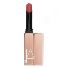 NARS Afterglow Sensual Shine Lipstick Dolce Vita swatch shows dusty rose color and luminous finish.