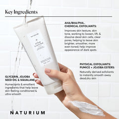 Naturium KP body scrub in shower being massaged for smooth skin.