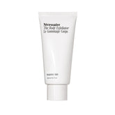 Nécessaire Body Exfoliator close-up shows volcanic pumice for gentle smoothing.