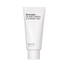 Nécessaire Body Exfoliator close-up shows volcanic pumice for gentle smoothing.