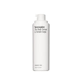 Nécessaire fragrance-free body serum bottle close-up for lightweight hydration.