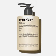 Rich foaming Nécessaire body wash on a clean shower scene.