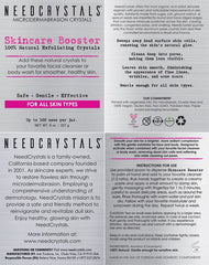NeedCrystals application massage crystals during facial exfoliation on skin.