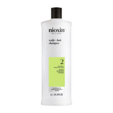 Nioxin System 2 Shampoo bottle on shelf suggesting scalp cleansing for progressed thinning