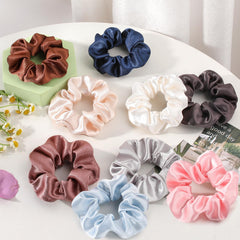 OCATO silk satin scrunchie on wrist for all-day comfort.