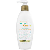 OGX Quenching Coconut Curls styling milk bottle pour for detangling and smooth frizz-free curls.