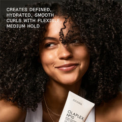 Olaplex No.10 bottle on damp hair highlights humidity resistance and smoothness.