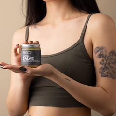 Close-up of Ora's Tattoo Salve texture showing balm-like moisture for skin