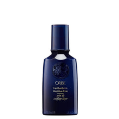 Oribe Feather Balm Ultra Light Bottle showcases weightless shine for fine hair.