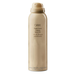 Applying Oribe Flash Form Finishing Spray Wax to hair sections for texture