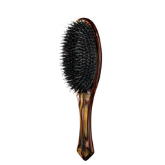 Oribe Flat Brush with Italian resin handle shows sleek design and comfortable grip.