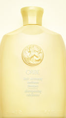 Oribe Hair Alchemy Resilience Shampoo bottle with gold cap conveys luxury for fragile hair.