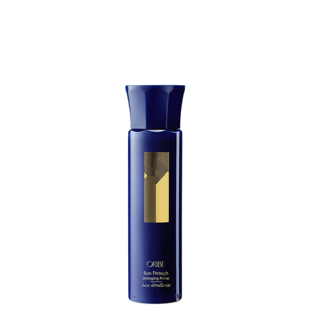Oribe Run-Through Detangler bottle offers a lightweight conditioning mist for silky, knot-free hair.