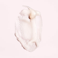 Oribe Serene Scalp Shampoo lather highlighting gentle cleansing for dry, itchy scalp.