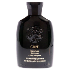 Oribe Signature Shampoo bottle pouring, providing a rich daily cleanse for all hair types.