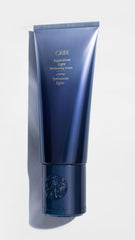 Oribe Supershine hands-apply-cream shows easy, smooth application.