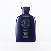 Oribe Supershine Hydrating Shampoo travel size bottle pour showcases premium formula for radiant shine