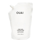 OUAI Fine Hair Conditioner refill bottle close-up showing sleek packaging for voluminous hair.